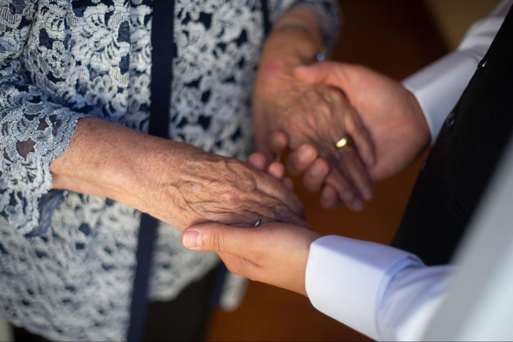 Family member providing support and care to an elderly adult during guardianship planning.
