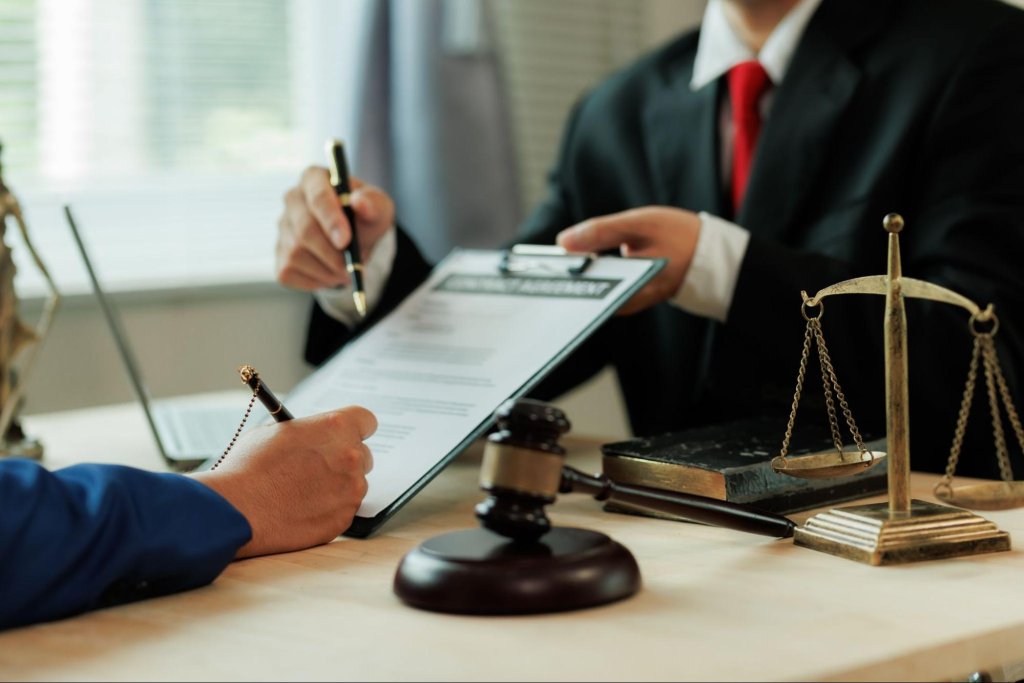 Divorce attorney reviewing legal paperwork related to property and financial settlement.