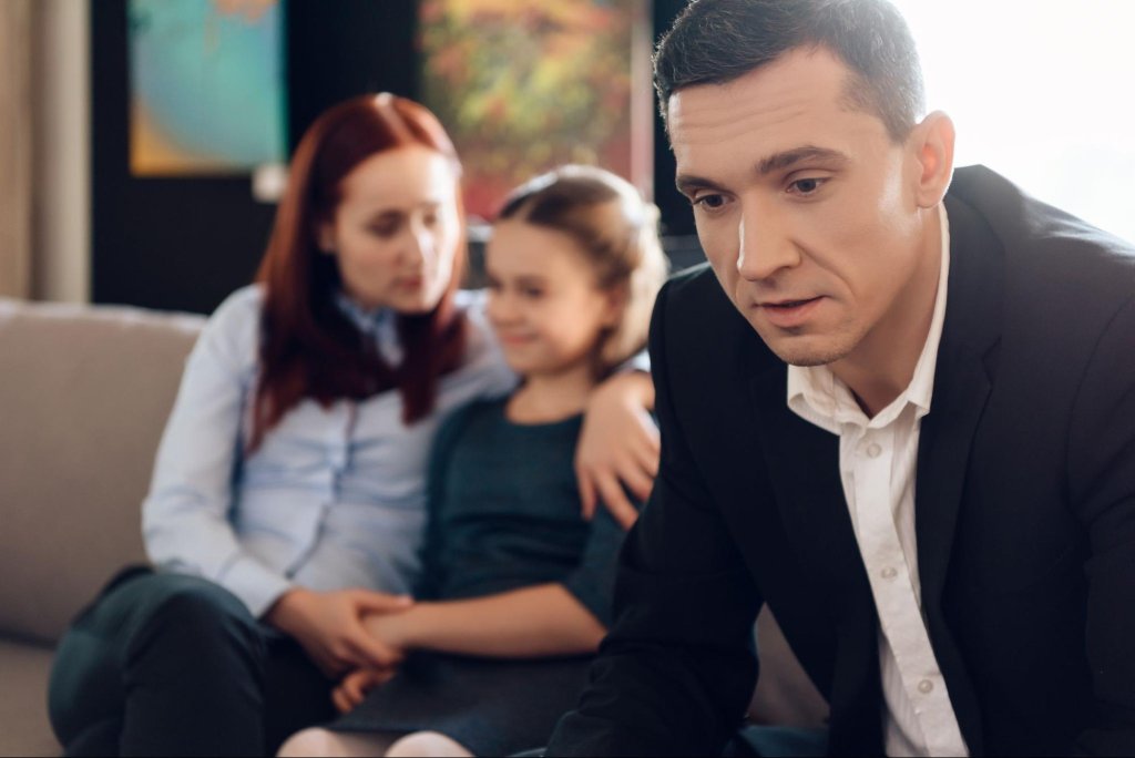 Parent discussing child support and family law concerns with a child nearby